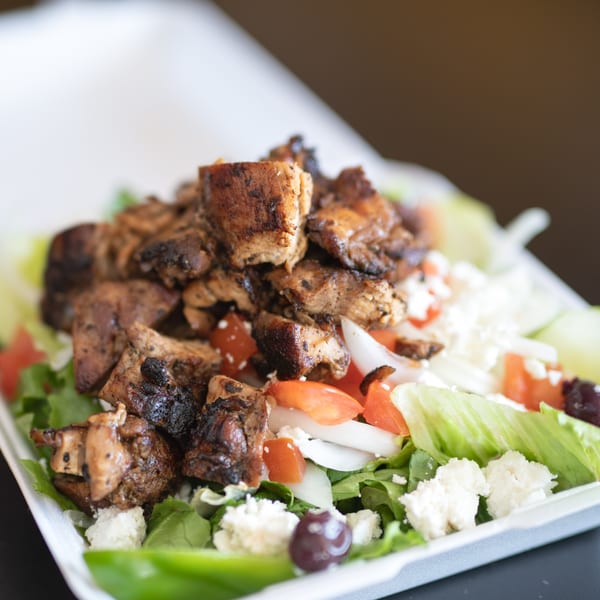 Canada Steak Burger's grilled chicken salad with lettuce, tomatoes, onions, feta cheese, and olives.